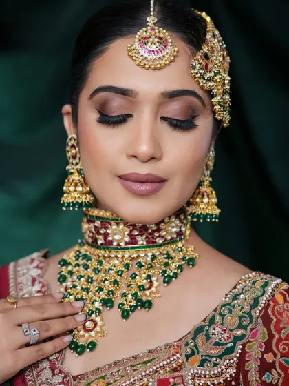 A close-up on the Nikah bridal makeup. The focus is on flawless skin and beautifully blended eyeshadow that enhances the eye shape. The matte lip color provides a perfect balance to the shimmer in the jewelry and outfit.