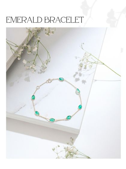 The dainty emerald bracelet, featuring oval-cut emeralds set along a simple gold chain. It's a classic piece that adds a touch of sophistication.