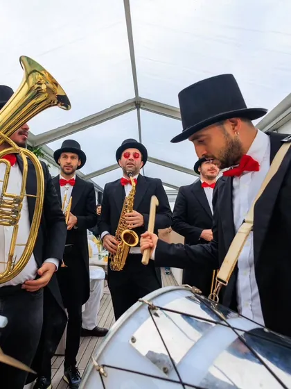 A live band in top hats and bow ties performs on a boat cruise in Istanbul. We believe in creating a festive atmosphere from the moment guests step aboard.