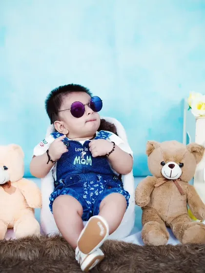 This six-month-old is full of style and personality, posing with sunglasses for his half-birthday shoot.