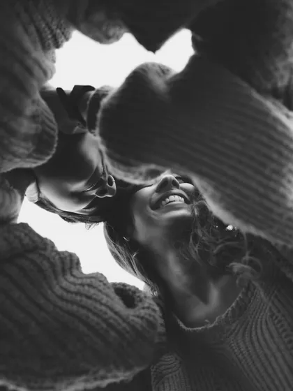 I often use creative angles to find a fresh perspective on a familiar moment. This low-angle shot captures the shared joy and intimacy between a couple, framed by their embrace.