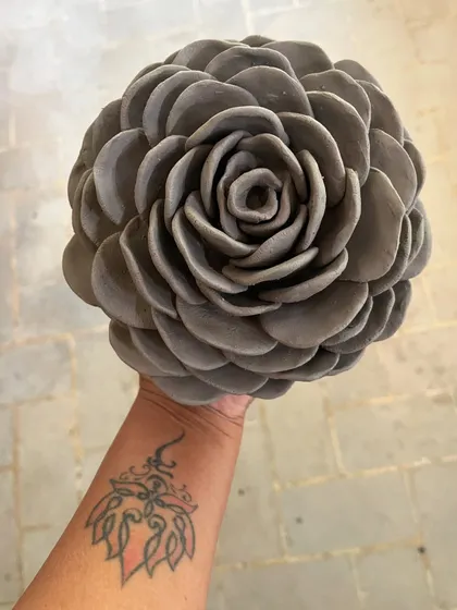 This beautiful clay rose sculpture was made entirely by hand, petal by petal. It's a great example of how you can create complex, organic forms using simple hand-building techniques.