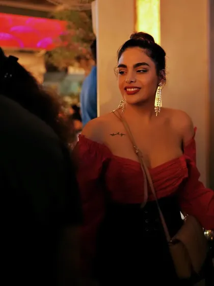 A guest looking chic and enjoying the Saturday night party.