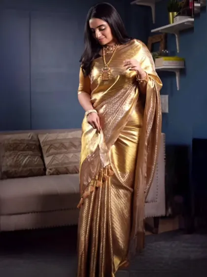 Working with luxurious fabrics like this golden tissue Banarasi is a joy. I draped this saree to capture its lightweight, shimmering quality, creating a look of pure elegance for a special event.