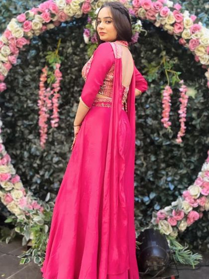 A view of the back of the pink palazzo suit, showing the stylish design. It’s a chic and practical choice for a wedding guest.