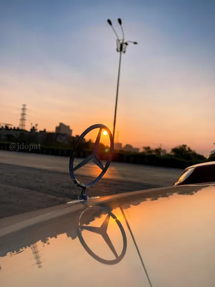 I focus on the small details that define a car's character. This is a sunset shot of a classic Mercedes-Benz hood ornament, with the sun perfectly aligned to create a starburst effect.