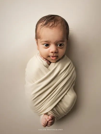 While sleepy shots are a classic, I also love capturing those moments when your newborn is awake and curious. This little one's wide-eyed gaze and tiny expression give a beautiful glimpse into the soul that has just joined your family.