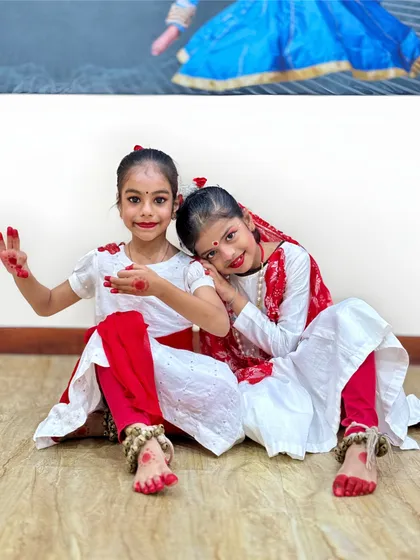 Two of our graceful 'gopiyan' pose after their Janmashtami performance. The red alta on their hands and feet, along with their ghungroos, completes the traditional Kathak look.