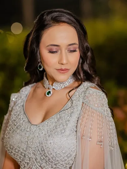 A close-up of the reception makeup, showing the soft, blended eyeshadow and the beautiful diamond and emerald necklace that the makeup complements perfectly.