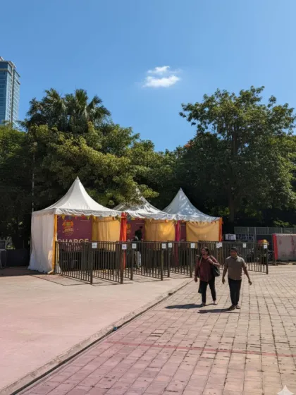 The entrance and ticketing area for the Dandiya event, featuring pagoda tents and queue barricades. I ensure the entry process is smooth and organized, even for large crowds.