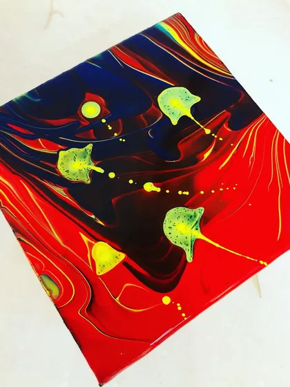 I call this one the 'jellyfish splash'. This is a fluid art piece where the colors interacted in an unexpected way, creating a design that reminds me of jellyfish floating in the ocean.