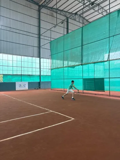 A junior player in action during the inter-academy matches in Ahmedabad, focused and ready for the next shot.