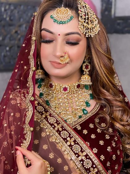 A close-up of the bride with her eyes closed, highlighting the flawless eye makeup with a soft cut-crease and shimmer.