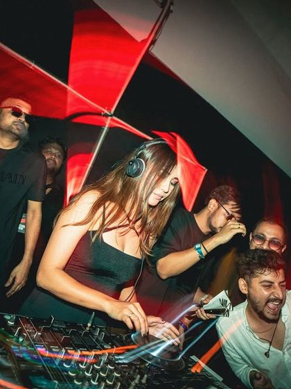 The party in full swing. Surrounded by friends and fans behind the decks, keeping the vibe high.