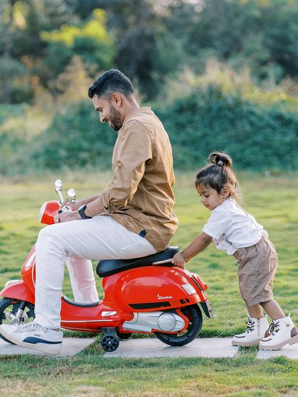 A father and son playing with a toy scooter. These playful moments show the fun side of fatherhood.