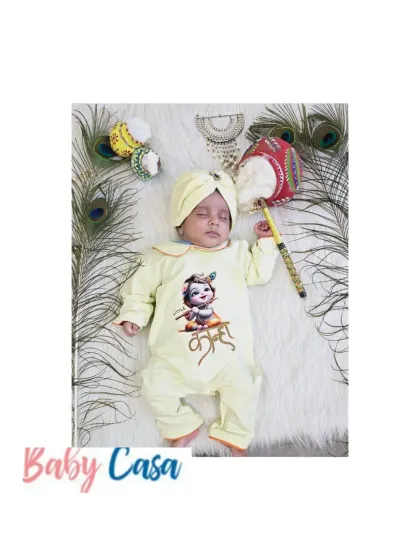 Tiny hands, divine grace. This baby is celebrating in a yellow "Little Kanha" printed romper, a comfortable and stylish choice for the festive season.