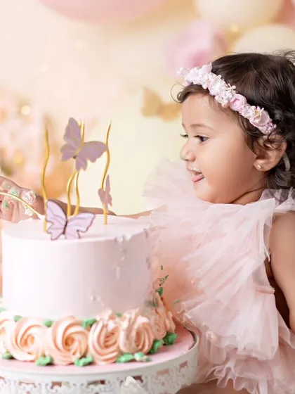 A sweet smile before she dives into the cake. The anticipation and excitement of a cake smash are so fun to capture.