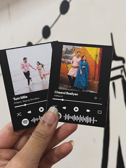 A pair of Spotify cards for a couple, featuring different photos and songs that are special to them.