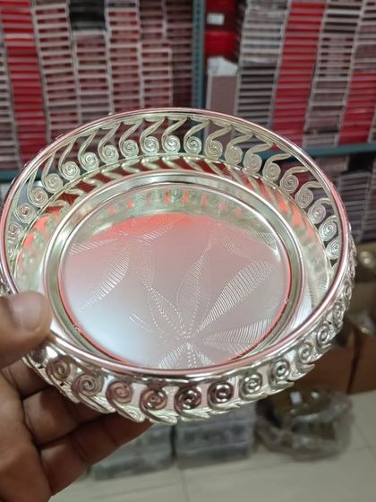 A hand-held view of the round German silver tray, showing its intricate swirled rim. I have these available in multiple sizes.