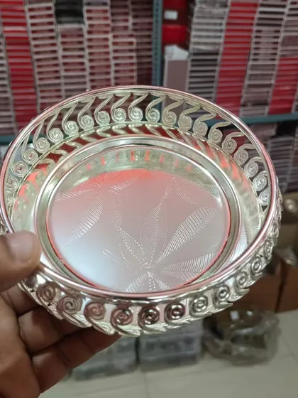 The same swirled-design tray shown in our warehouse, highlighting its shiny finish and the large stock we maintain.
