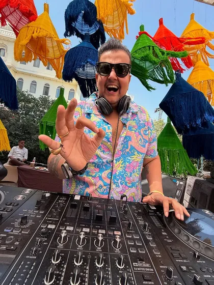 A close-up of me at the decks, giving the 'OK' sign. Everything is perfect, the vibe is right.