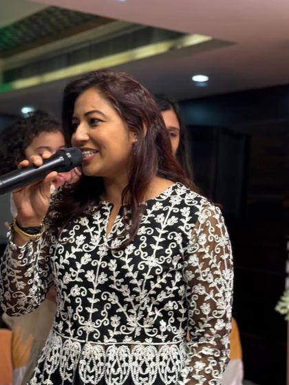 Mic in hand, ready to get the Bandola party started. My goal is to make everyone feel welcome and excited for the evening ahead.