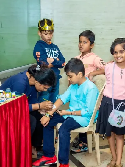 Here you can see the face painting station in action. Kids can watch as their friends get painted, building excitement for their turn.
