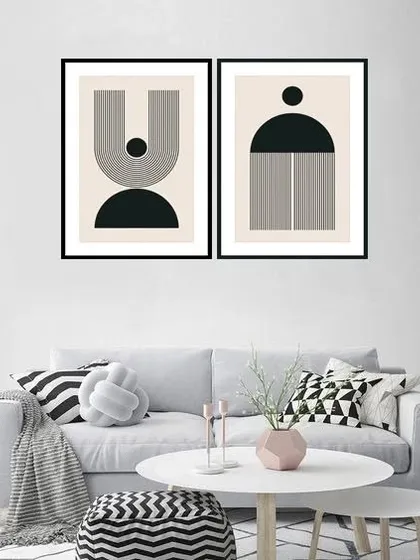 A set of two framed prints featuring austere geometric shapes in black and white. This minimalist artwork is perfect for a modern living room, adding a touch of graphic sophistication. Frame color and size are customizable.
