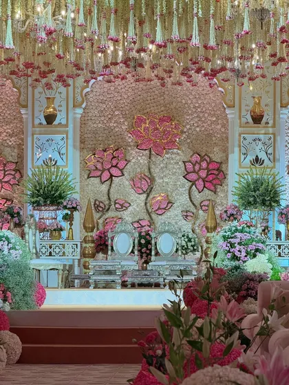 A focused shot of the central mandap area, highlighting the stunning lotus backdrop and the regal couple's seating. The attention to detail is evident in every flower.