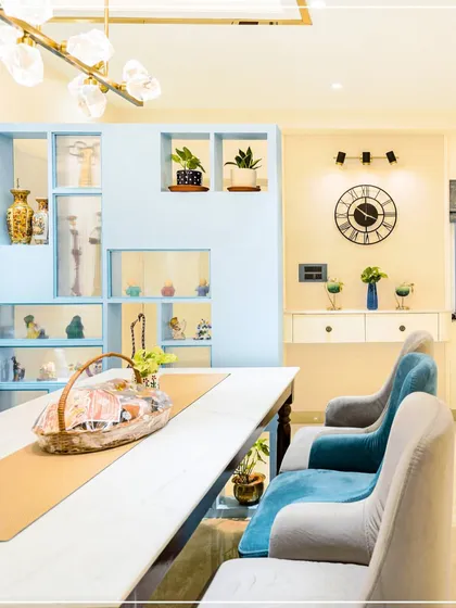 A close-up of the dining area from image 102, showing the tufted blue bench seating and modern lighting.