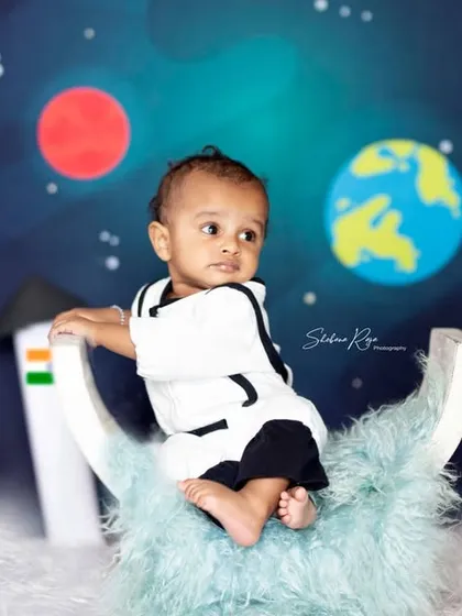 Being an astronaut is tough work. This little one is taking a break on the moon during his imaginative space-themed baby photoshoot.