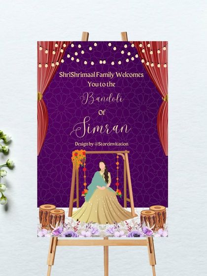A stunning welcome sign for a Bandoli function. The rich purple background with a subtle pattern is complemented by illustrations of drapes, string lights, and the bride on a decorated swing, creating a festive and royal look.
