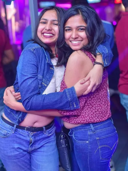 The best part of my job is seeing the results on the dance floor. These two friends are hugging and smiling, capturing the fun and positive atmosphere I strive to create at every party.