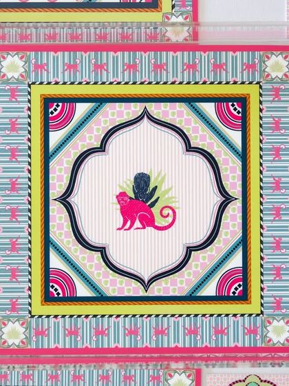 This vibrant 'Tropical Tapestry' print features a playful pink monkey motif within a geometric, tapestry-style frame. It was designed for House of Happy and looks stunning on their table settings.