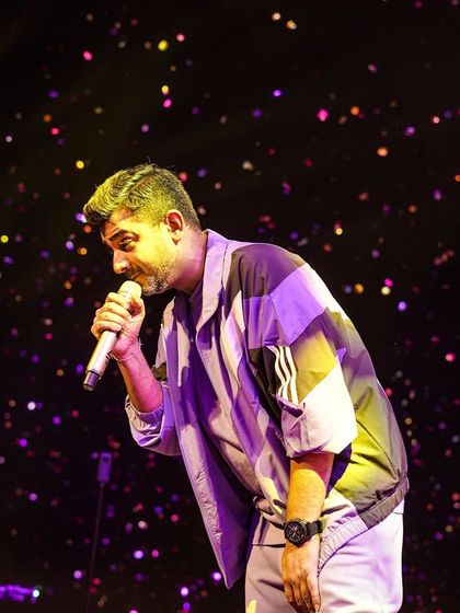 Jigar Saraiya engaging with the audience under a shower of confetti at NIT Surat. We focus on creating an immersive and interactive show for the students.