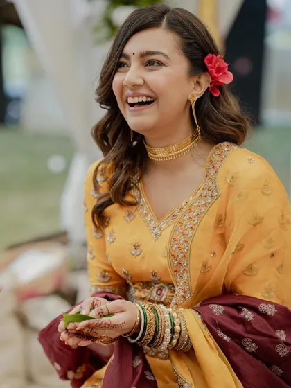 The bride's infectious laughter is the highlight of this candid shot, a moment of pure joy during her wedding ceremony.