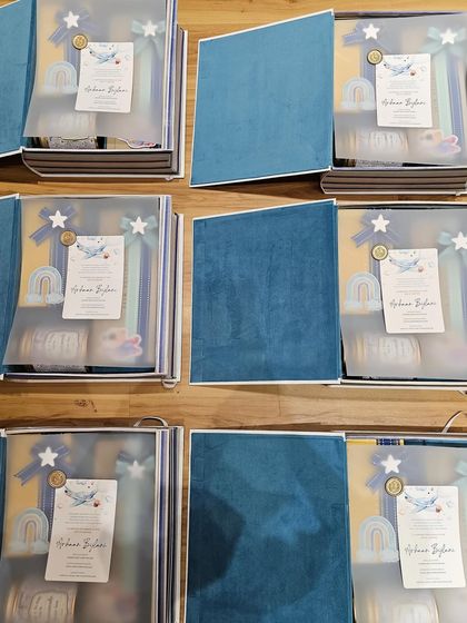 Welcoming a baby with my adorable book boxes. This image shows the boxes open, revealing the beautifully curated and wrapped gifts inside, each with its own custom touch.