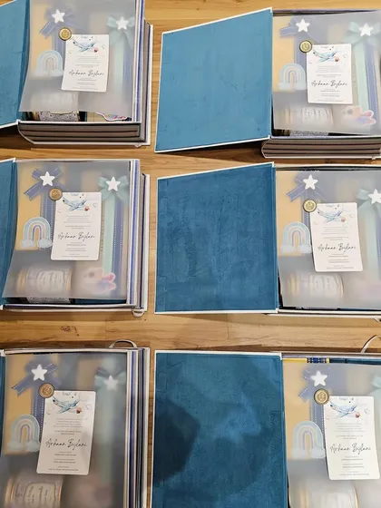Welcoming a baby with my adorable book boxes. This image shows the boxes open, revealing the beautifully curated and wrapped gifts inside, each with its own custom touch.