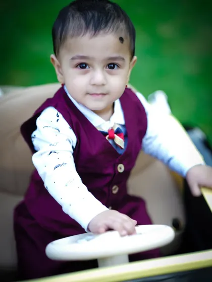 A handsome close-up of our little driver, looking dapper in his vest and bow tie.