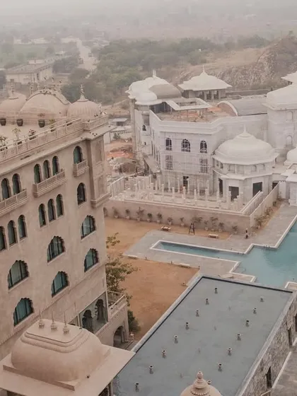 An aerial view of the magnificent Fairmont Jaipur, showcasing the sprawling property and its royal architecture. A perfect canvas for a grand destination wedding.