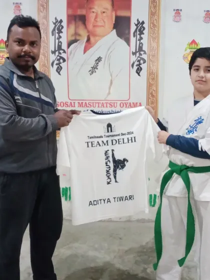 Aditya Tiwari receives his "Team Delhi" t-shirt. He is ready to represent our dojo.
