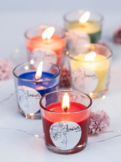 A shot of our colorful shot glass candles, all lit up. The simple design allows the vibrant colors and custom labels to stand out, making them versatile for any theme.