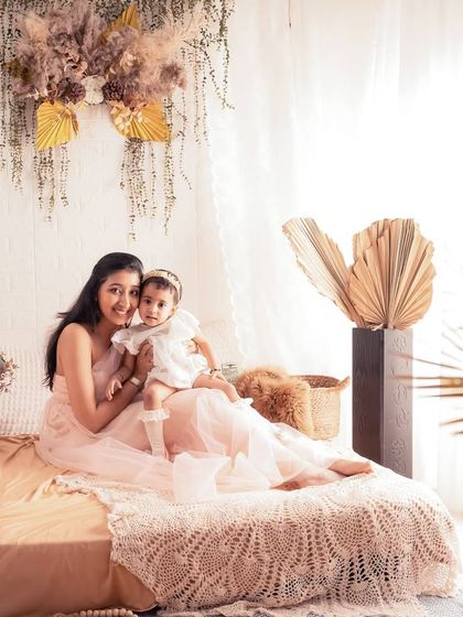 Another angle of this beautiful mother-daughter duo. The natural light from the window and the soft textures of the decor create a warm and inviting atmosphere.