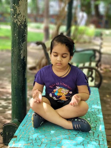 A moment of quiet meditation for a young student during our outdoor yoga session. It's wonderful to see them find stillness amidst the open space.