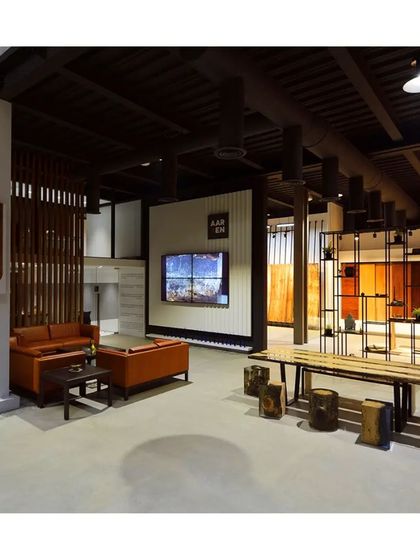 An inviting commercial interior with rustic wooden furniture and display shelves, creating a warm and comfortable ambiance for clients.