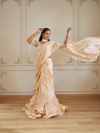 The 'Luster' draped saree in motion. The lightweight fabric and elegant drape make it a stunning choice for a pre-wedding shoot or a sophisticated event.