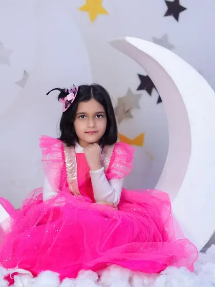 This young lady is pretty in pink, sitting gracefully on our moon and stars set for her birthday photoshoot.