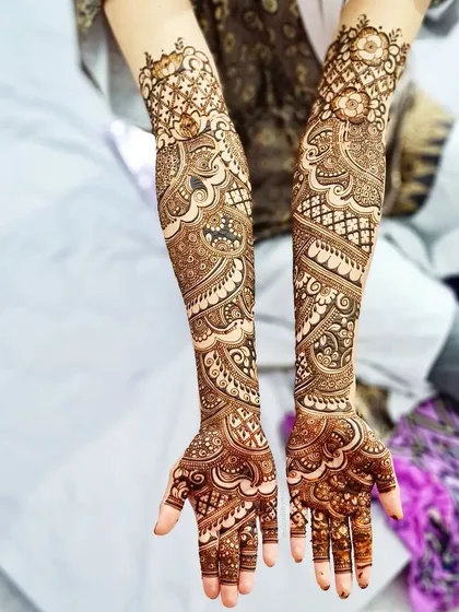 This full-coverage bridal design for Huda was inspired by another artist's work and customized for her. It features a mix of paisleys, florals, and geometric patterns.