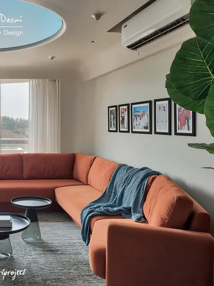 The living room in the Agra Fort Project features a large, comfortable L-shaped sofa in a bold burnt orange color. It’s the perfect spot for the family to lounge and enjoy the view.
