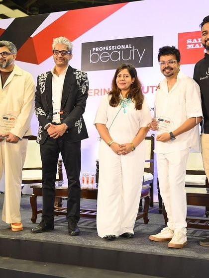 Posing with fellow speakers on stage after a successful and insightful session at the Salon Management Congress.